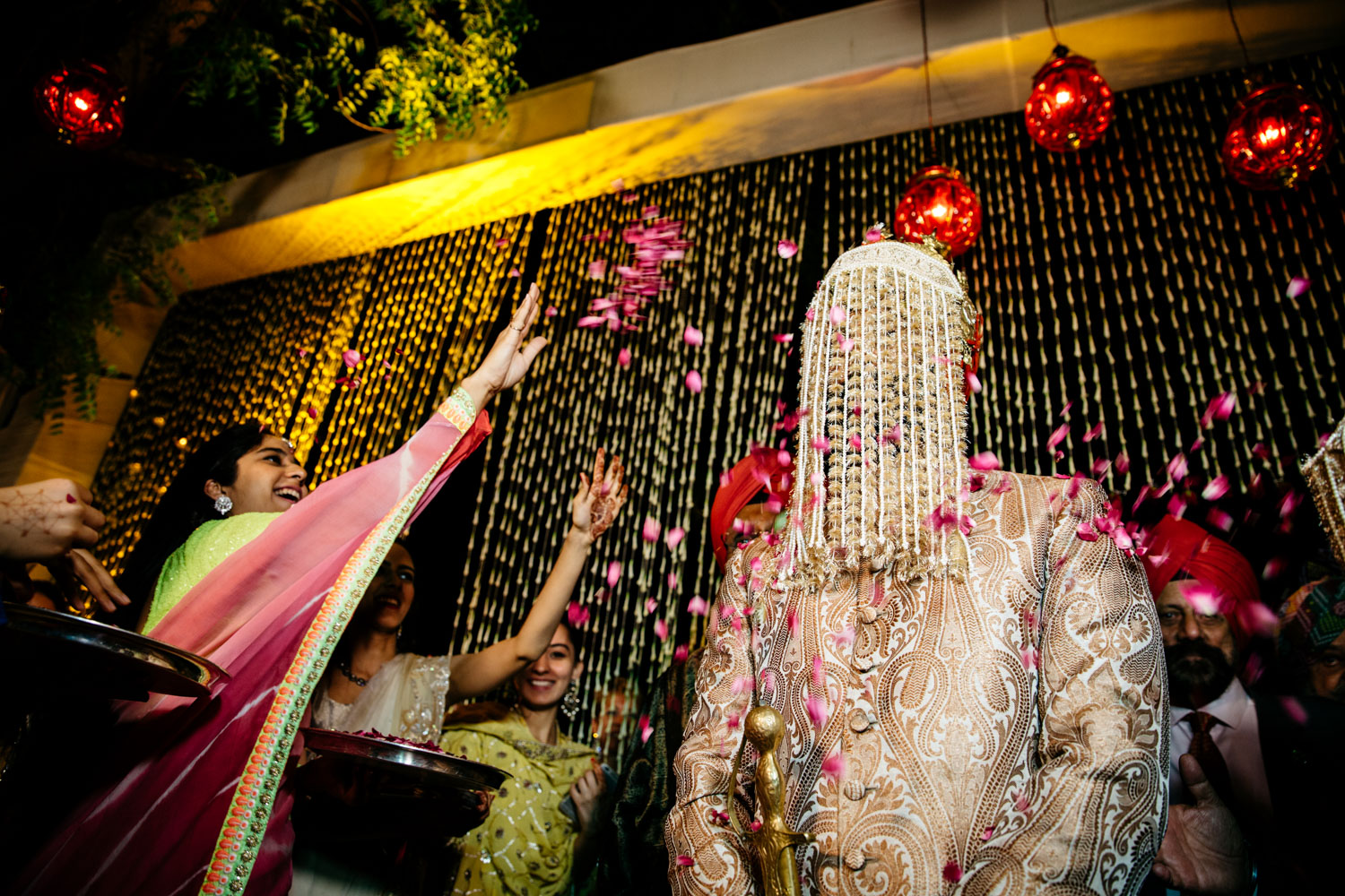 Rose petals showering over groom's sehra