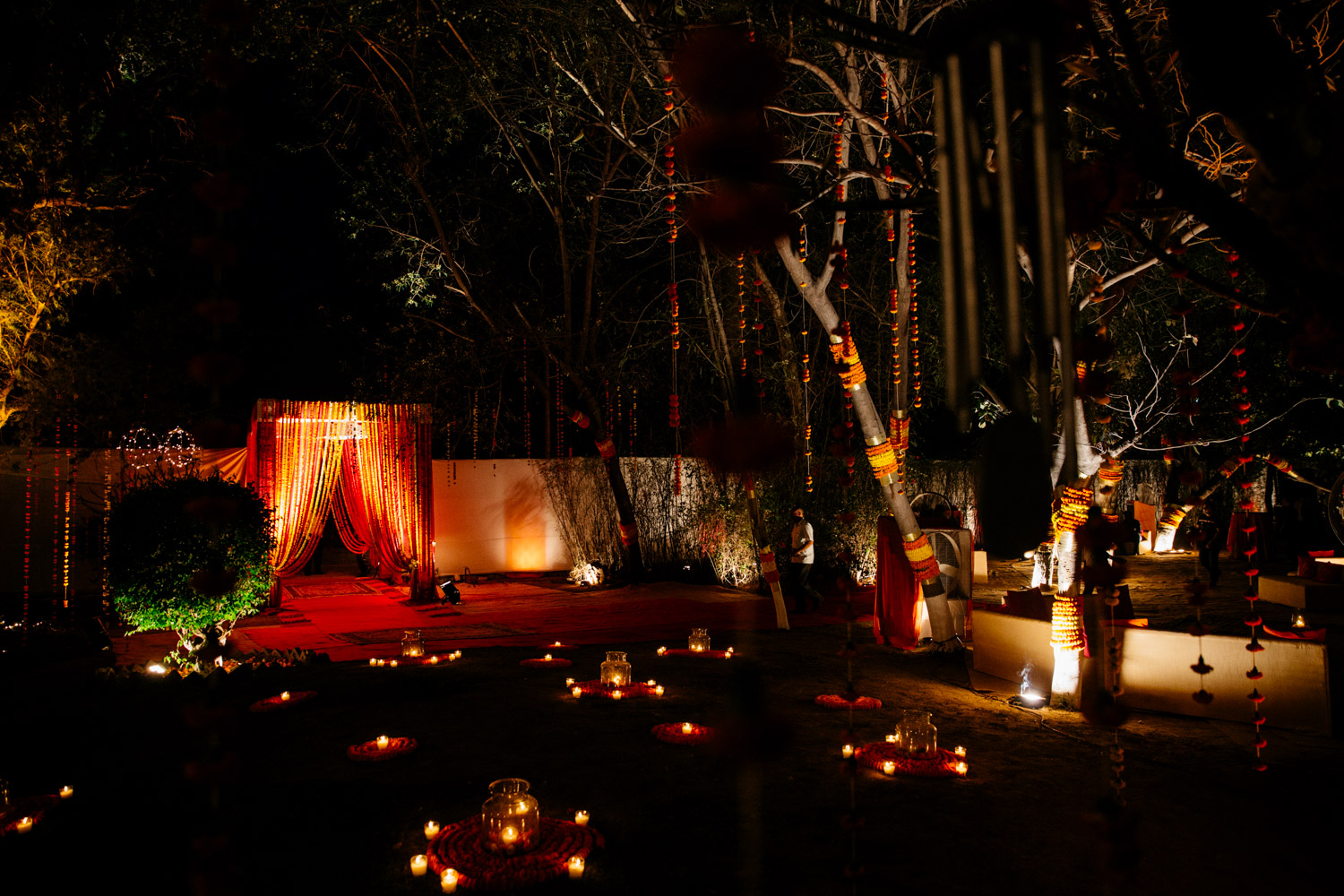Night view of lit venue with draped marigolds