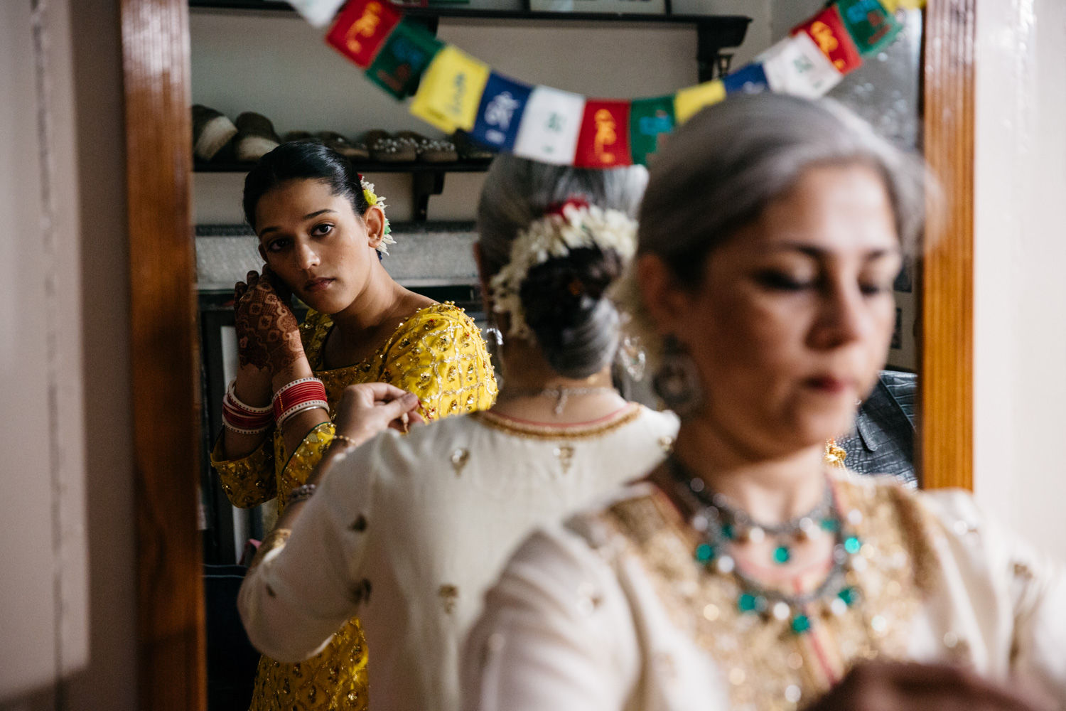 Bride looking at herself in mirror