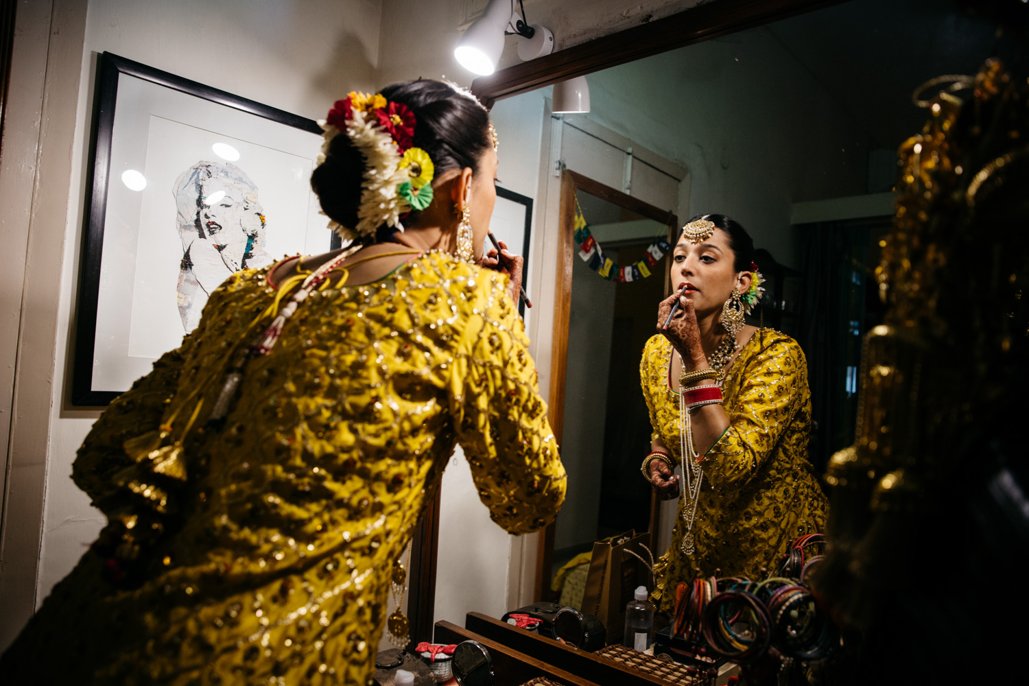Bride applying lipstick