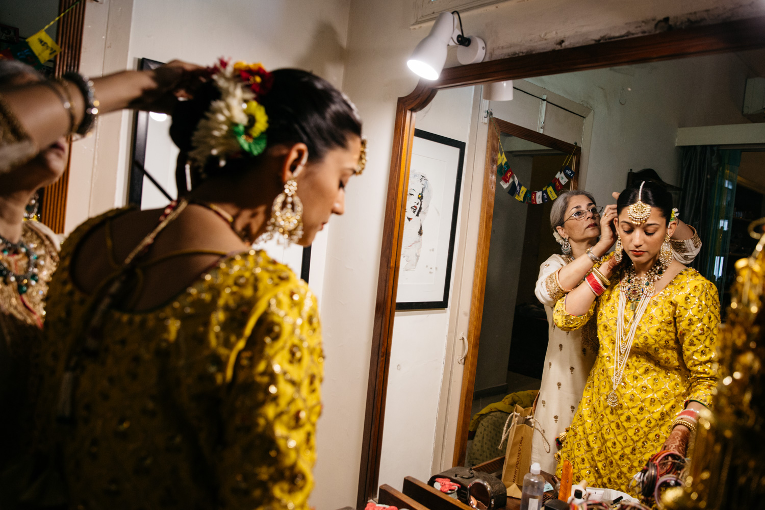 Mother and bride reflecting in ornate mirror