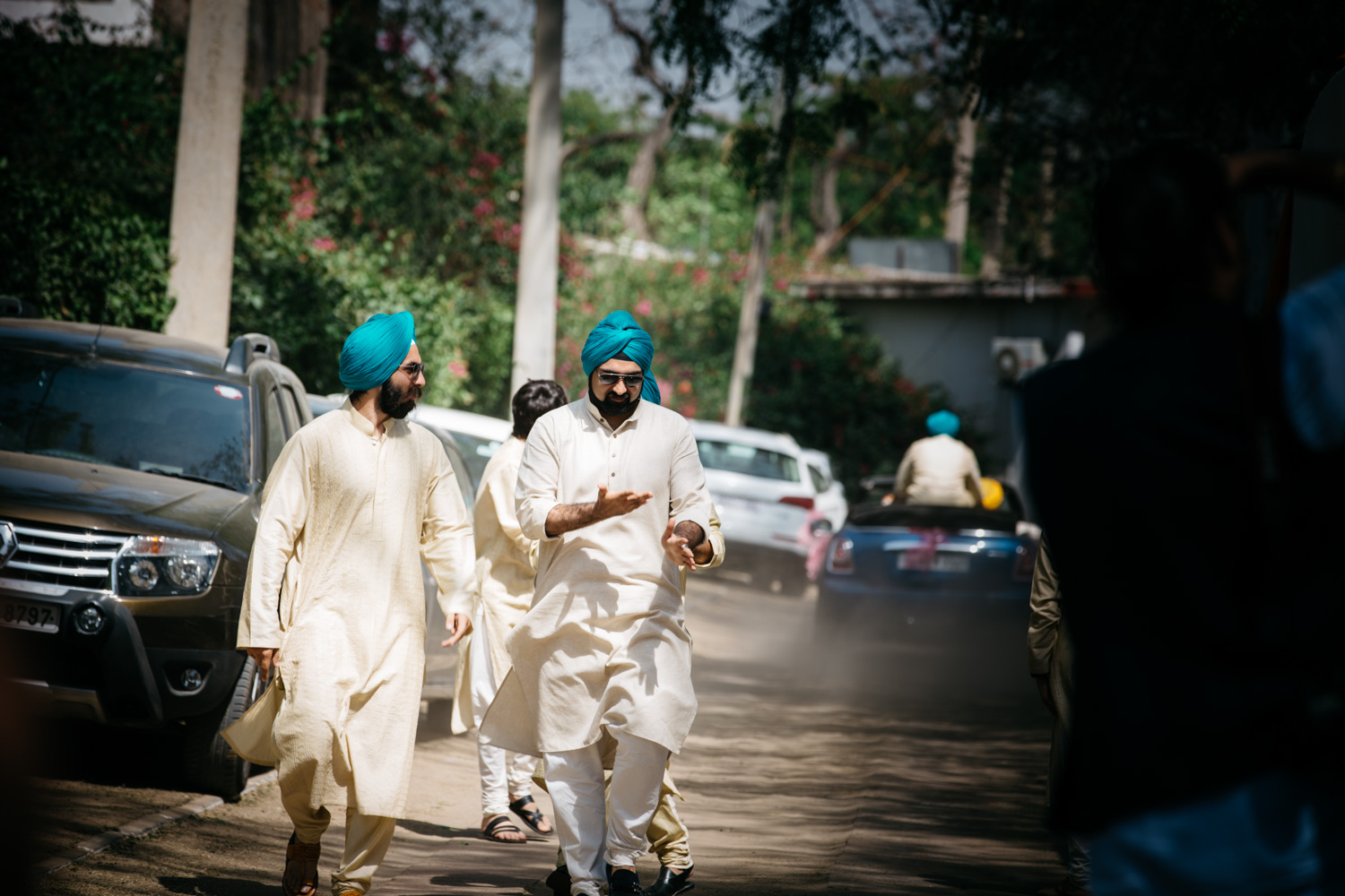 Men walking on dusty road