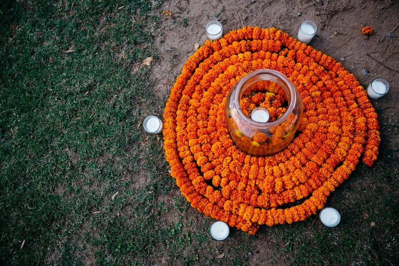 Marigold spiral with glass candles on lawn
