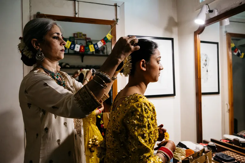 Mother helping with bride's hair