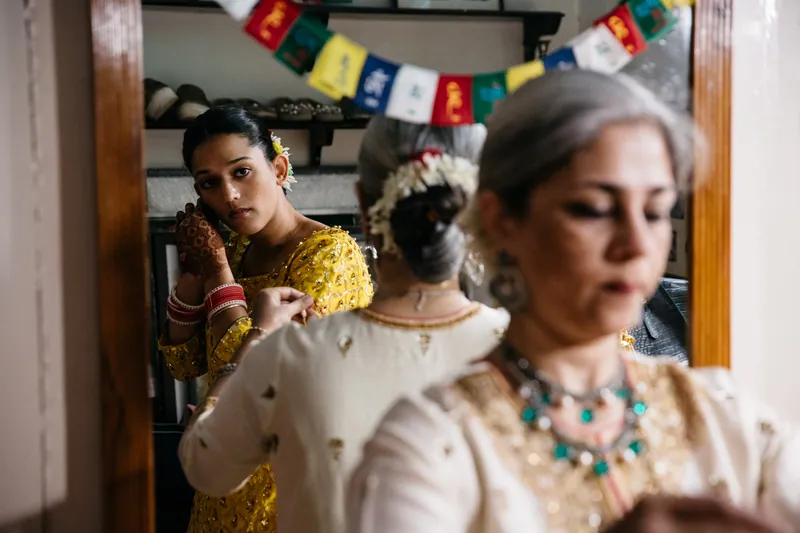 Bride looking at herself in mirror