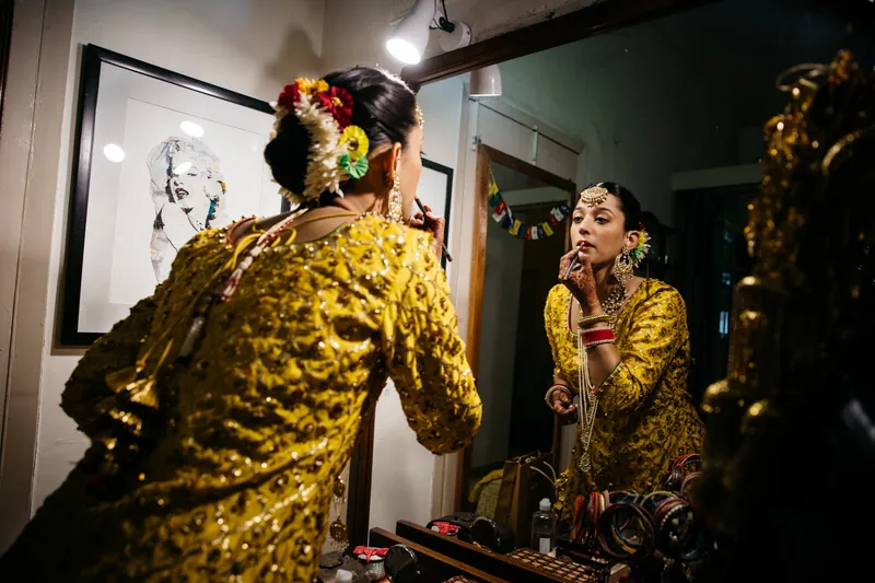 Bride applying lipstick
